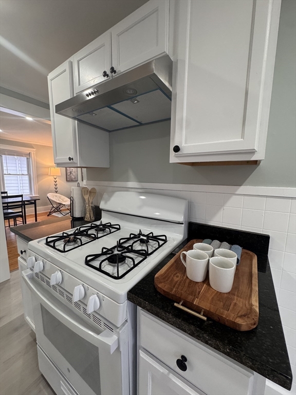 18 Emerald Avenue, Unit 2 Webster, MA 01570 - Photo 5 of 26 a white stove top oven sitting inside of a kitchen