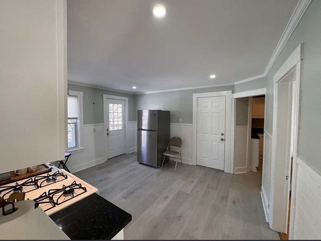 18 Emerald Avenue, Unit 2 Webster, MA 01570 - Photo 6 of 26 a view of an empty room and wooden floor kitchen view
