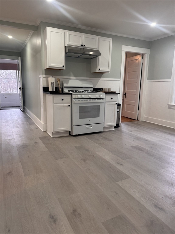 18 Emerald Avenue, Unit 2 Webster, MA 01570 - Photo 8 of 26 a kitchen with stainless steel appliances a stove and white cabinets
