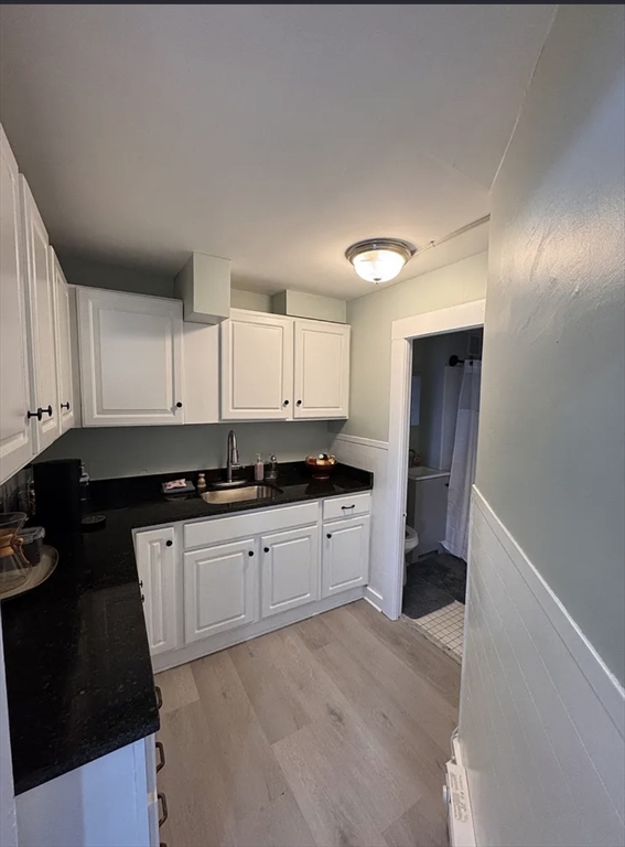 18 Emerald Avenue, Unit 2 Webster, MA 01570 - Photo 9 of 26 a kitchen with granite countertop a sink and cabinets