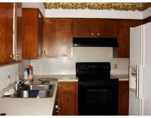a kitchen with a sink cabinets and appliances