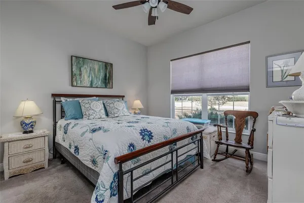 a bed room with a bed and a chandelier