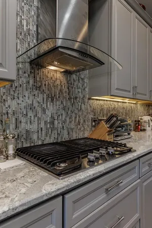a stove top oven sitting inside of a kitchen
