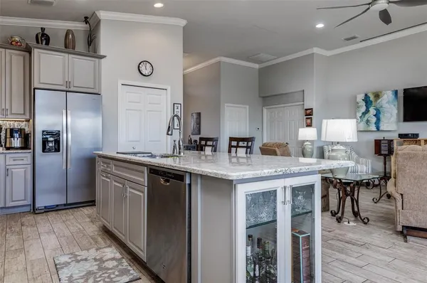 a kitchen with center island and stainless steel appliances
