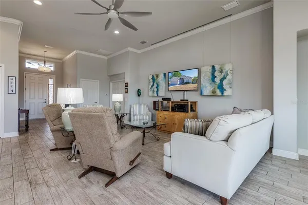 a living room with furniture and painting on the wall