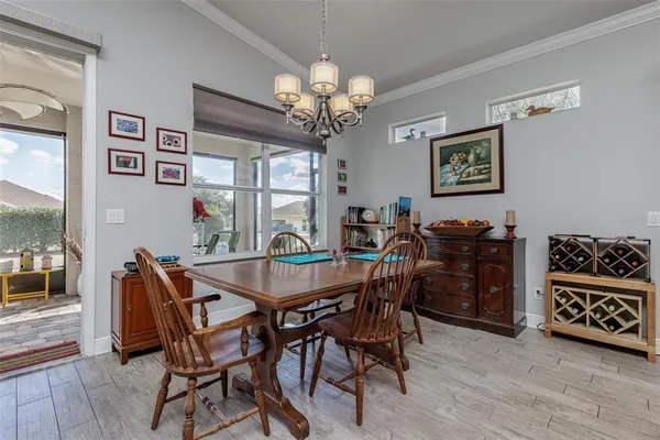 a view of a dining room with furniture and chandelier