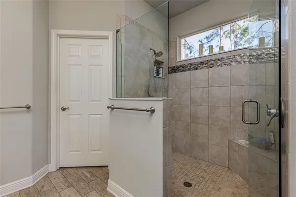 a bathroom with a glass shower door