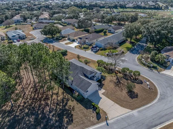 an aerial view of a house with a yard and lake view