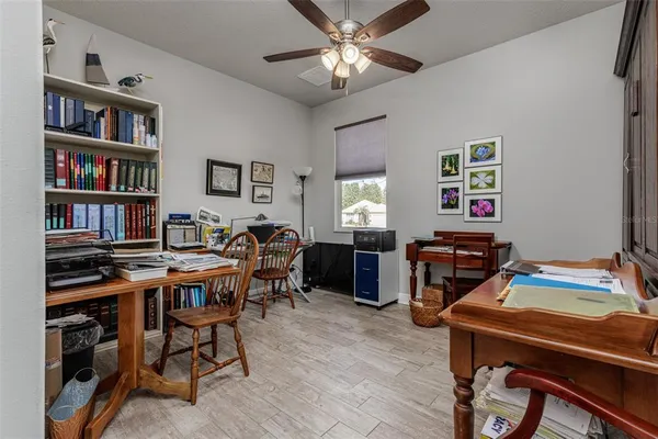 a view of a workspace with furniture and a bookshelf