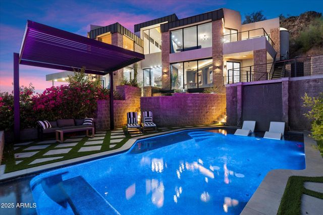 a view of a chairs with a table in front of building