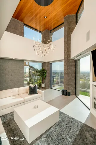 a spacious bedroom with a bed and a chandelier