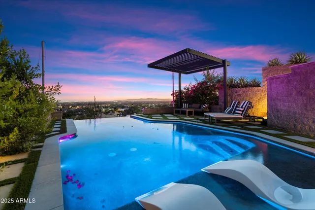 a view of a balcony with chairs and a potted plant