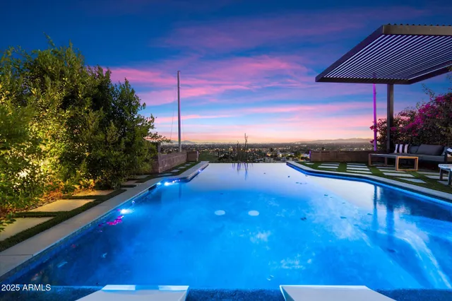 a backyard of a house with barbeque oven table and chairs