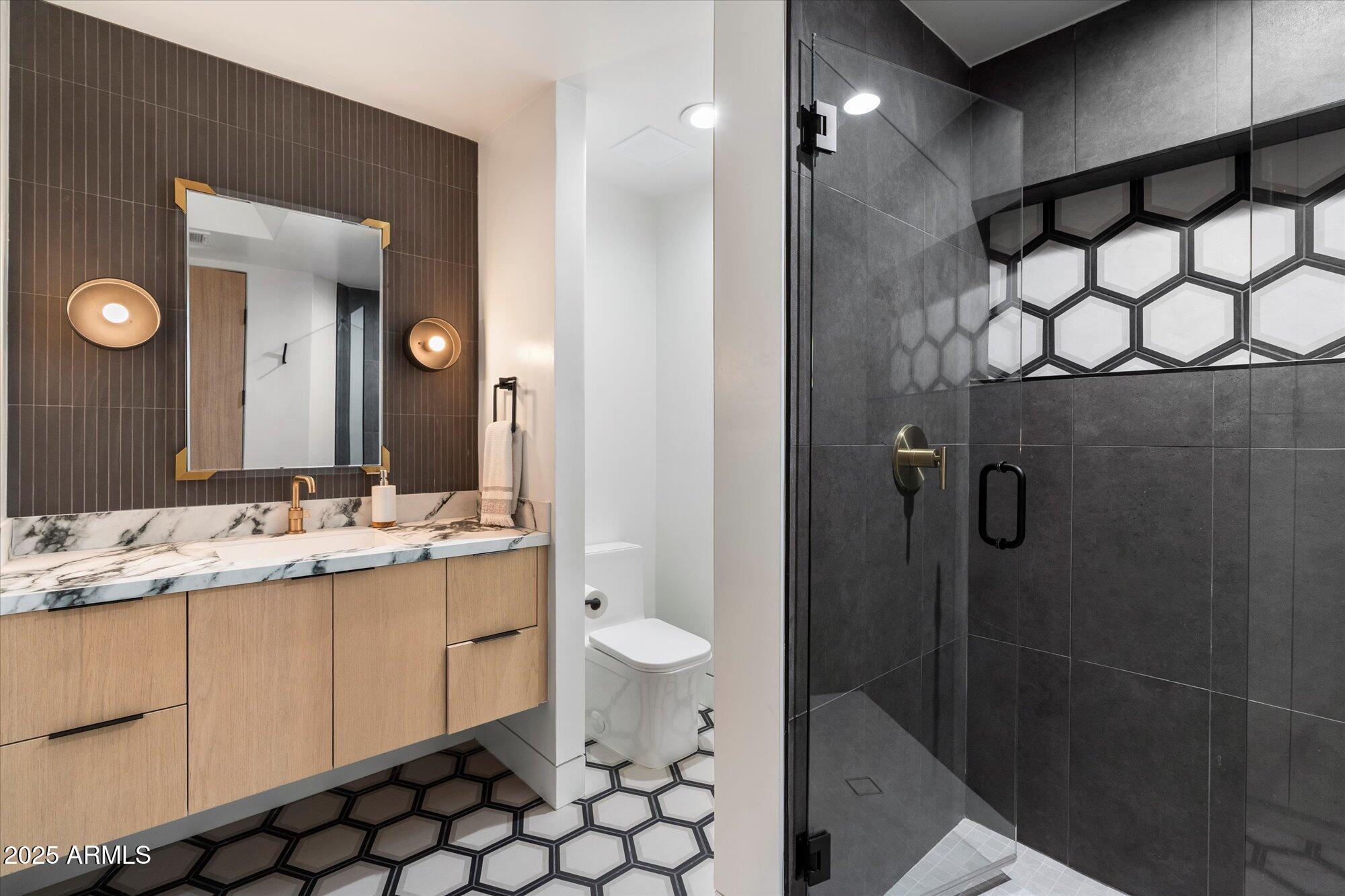 7147 North 23rd Place Phoenix, AZ 85016 - Photo 73 of 103 a bathroom with a double vanity sink toilet and shower