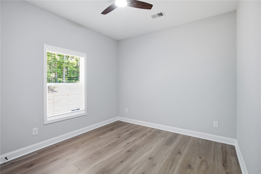 912 Watercrest Road West Union, SC 29696 - Photo 27 of 49 This bright room features a large window, a ceiling fan, and modern flooring.