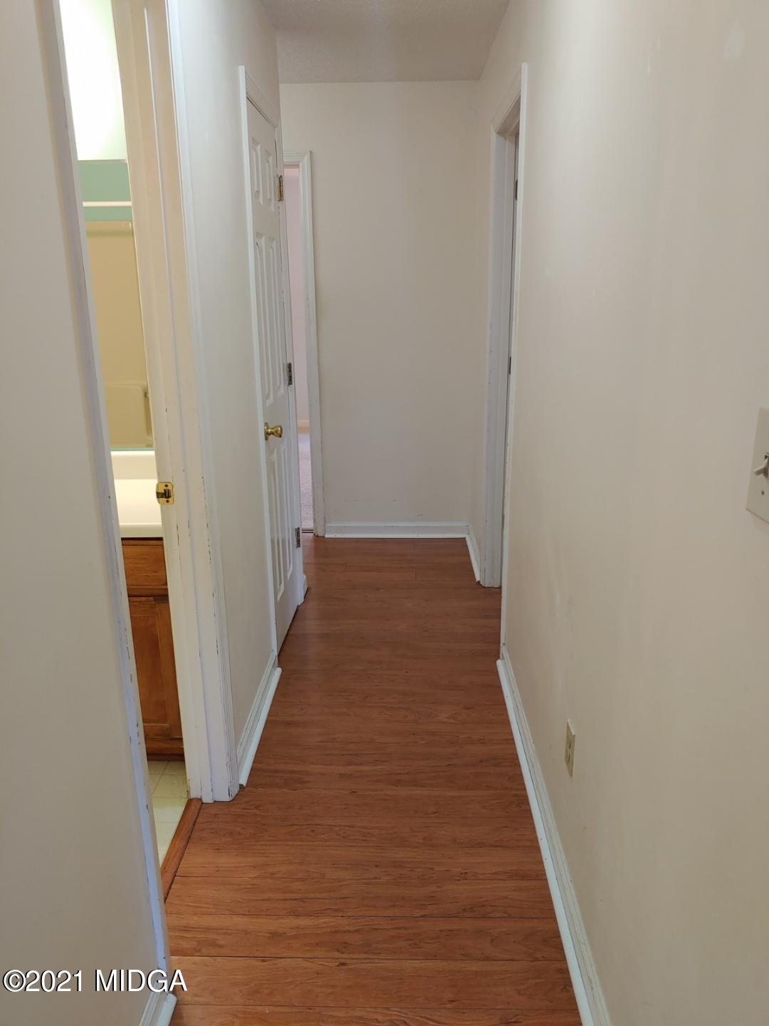 6210 Skipperton Road Macon, GA 31216 - Photo 11 of 15 a view of a hallway with wooden floor and staircase