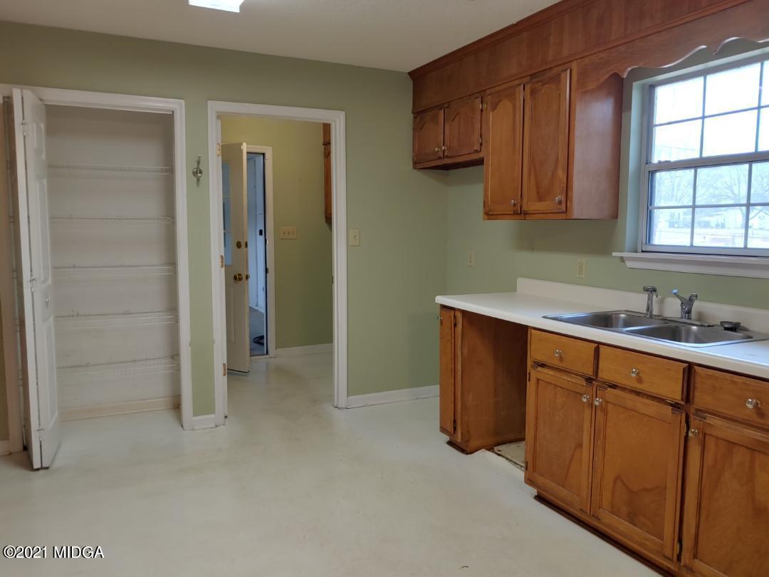 6210 Skipperton Road Macon, GA 31216 - Photo 13 of 15 a kitchen with stainless steel appliances granite countertop a sink and cabinets with wooden floor