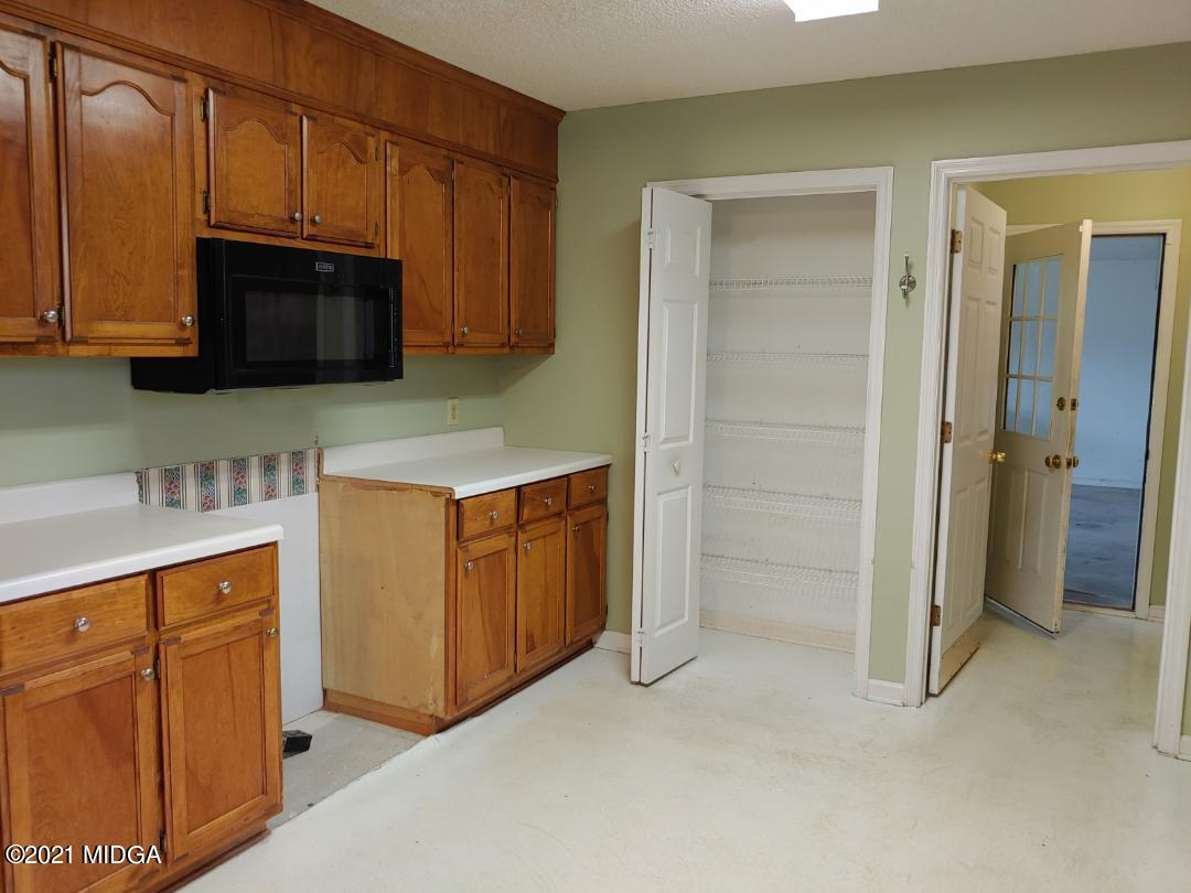 6210 Skipperton Road Macon, GA 31216 - Photo 14 of 15 a kitchen with stainless steel appliances granite countertop a refrigerator and a sink