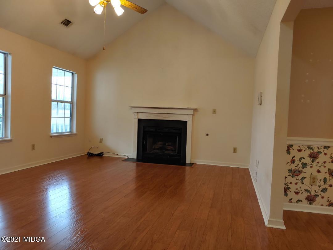 6210 Skipperton Road Macon, GA 31216 - Photo 6 of 15 an empty room with windows and fireplace
