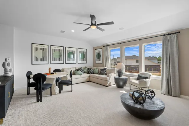 a living room with furniture and a large window