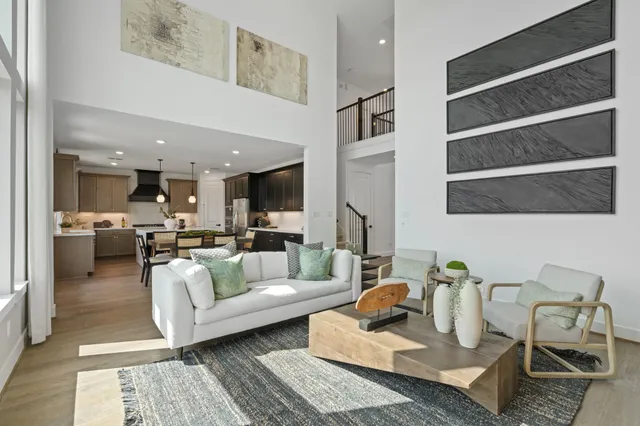 a living room with furniture and a view of kitchen