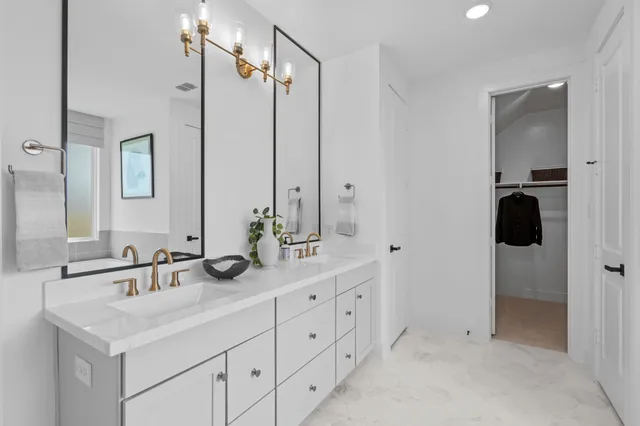 a bathroom with a double vanity sink and mirror