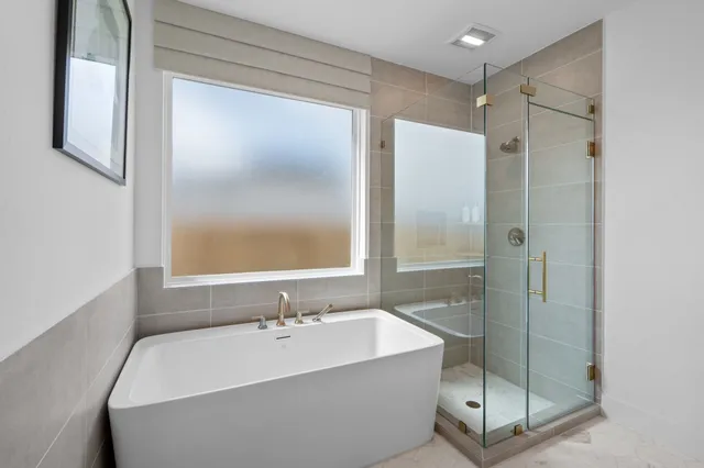 a bathroom with a bathtub and a shower