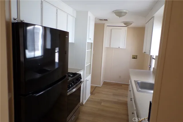 a kitchen with a refrigerator and a stove