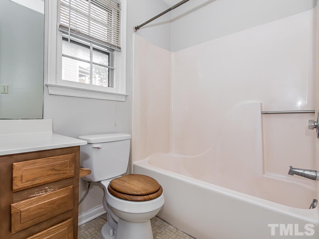 3509 Wickersham Way Raleigh, NC 27604 - Photo 18 of 24 a bathroom with a sink a toilet and bathtub