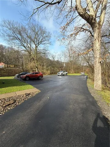 a view of a patio with lawn chairs under an umbrella