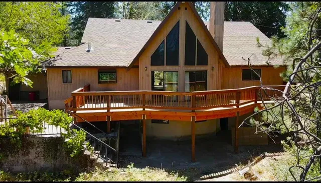an aerial view of a house with swimming pool and garden