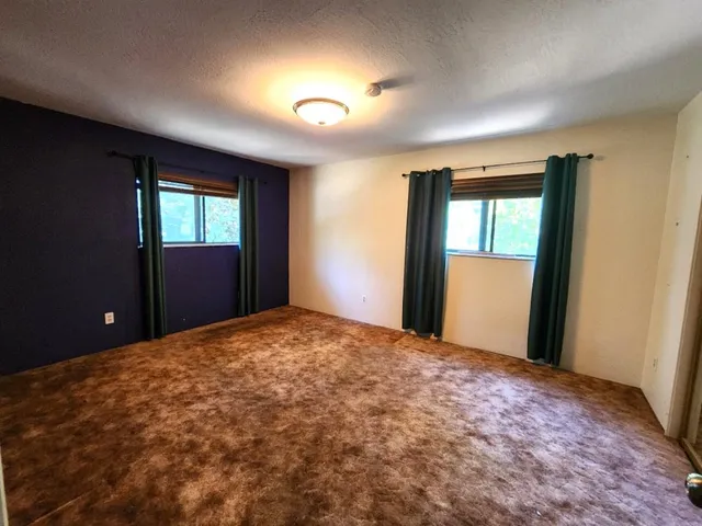 a view of a backyard with sitting area