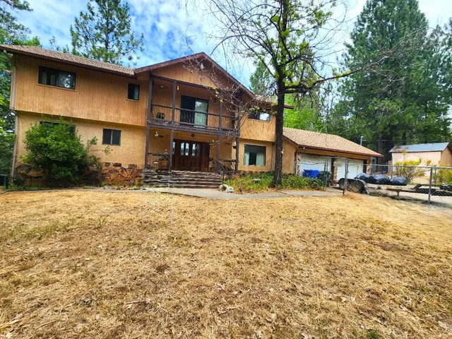 a view of a hallway with wooden floor and a bathroom