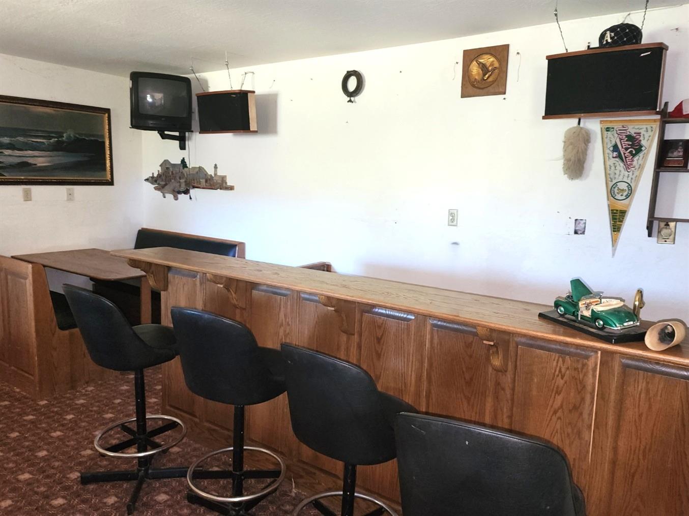 1925 Skull Flat Road West Point, CA 95255 - Photo 42 of 86 a kitchen with stainless steel appliances kitchen island granite countertop a sink and a wooden cabinets