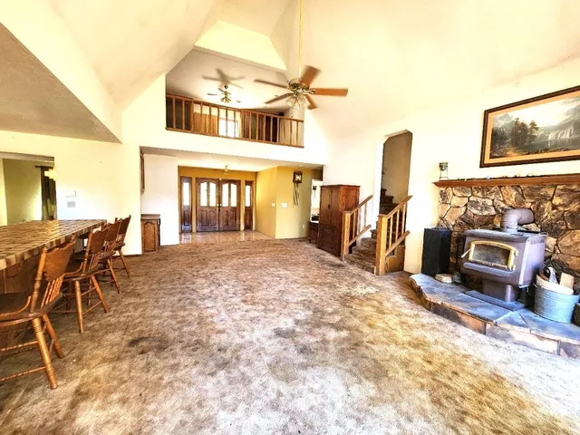 a view of a hallway with wooden floor and stairs