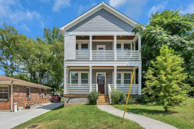 a view of house with a yard