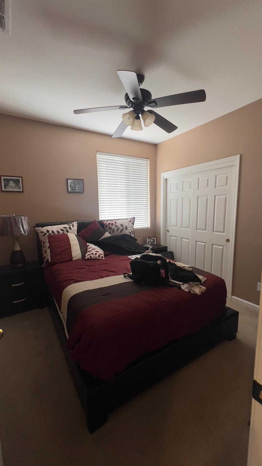 5221 East Byrd Avenue Fresno, CA 93725 - Photo 11 of 15 a bed room with a bed and a ceiling fan