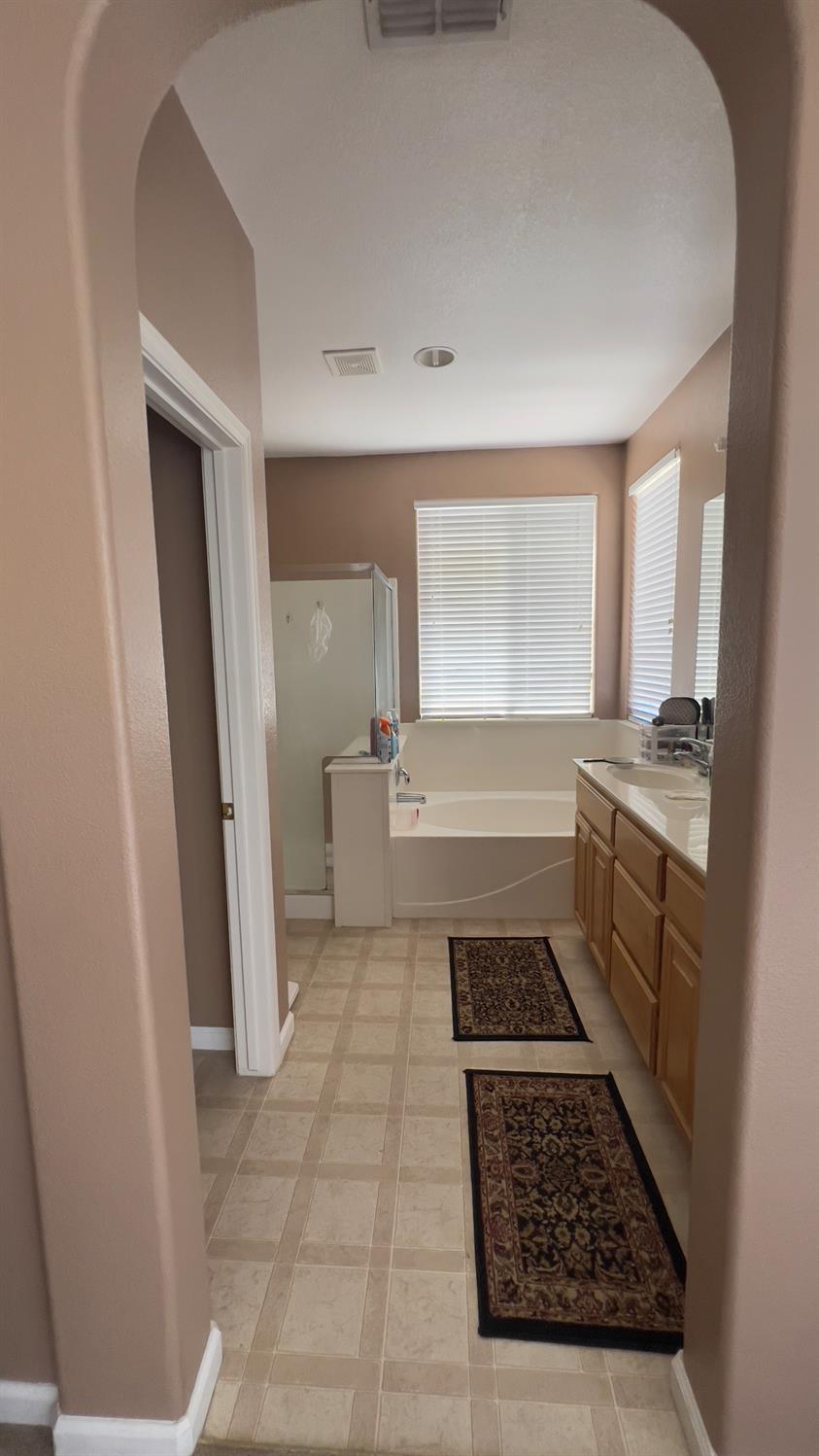 5221 East Byrd Avenue Fresno, CA 93725 - Photo 14 of 15 a kitchen with sink stove and cabinets
