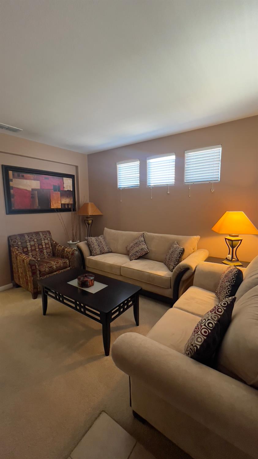 5221 East Byrd Avenue Fresno, CA 93725 - Photo 3 of 15 a living room with furniture and a lamp