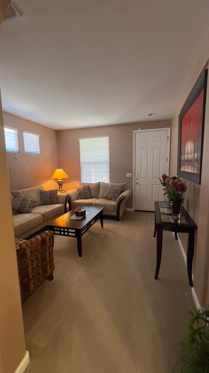 5221 East Byrd Avenue Fresno, CA 93725 - Photo 4 of 15 a living room with furniture a window and a flat screen tv