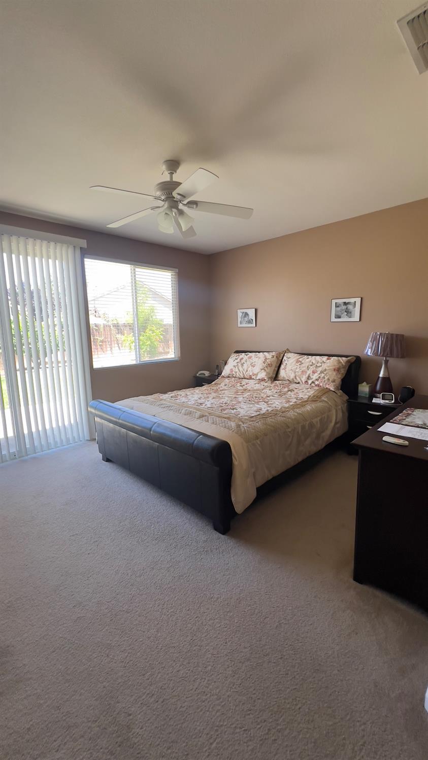 5221 East Byrd Avenue Fresno, CA 93725 - Photo 9 of 15 a bedroom with bed and window
