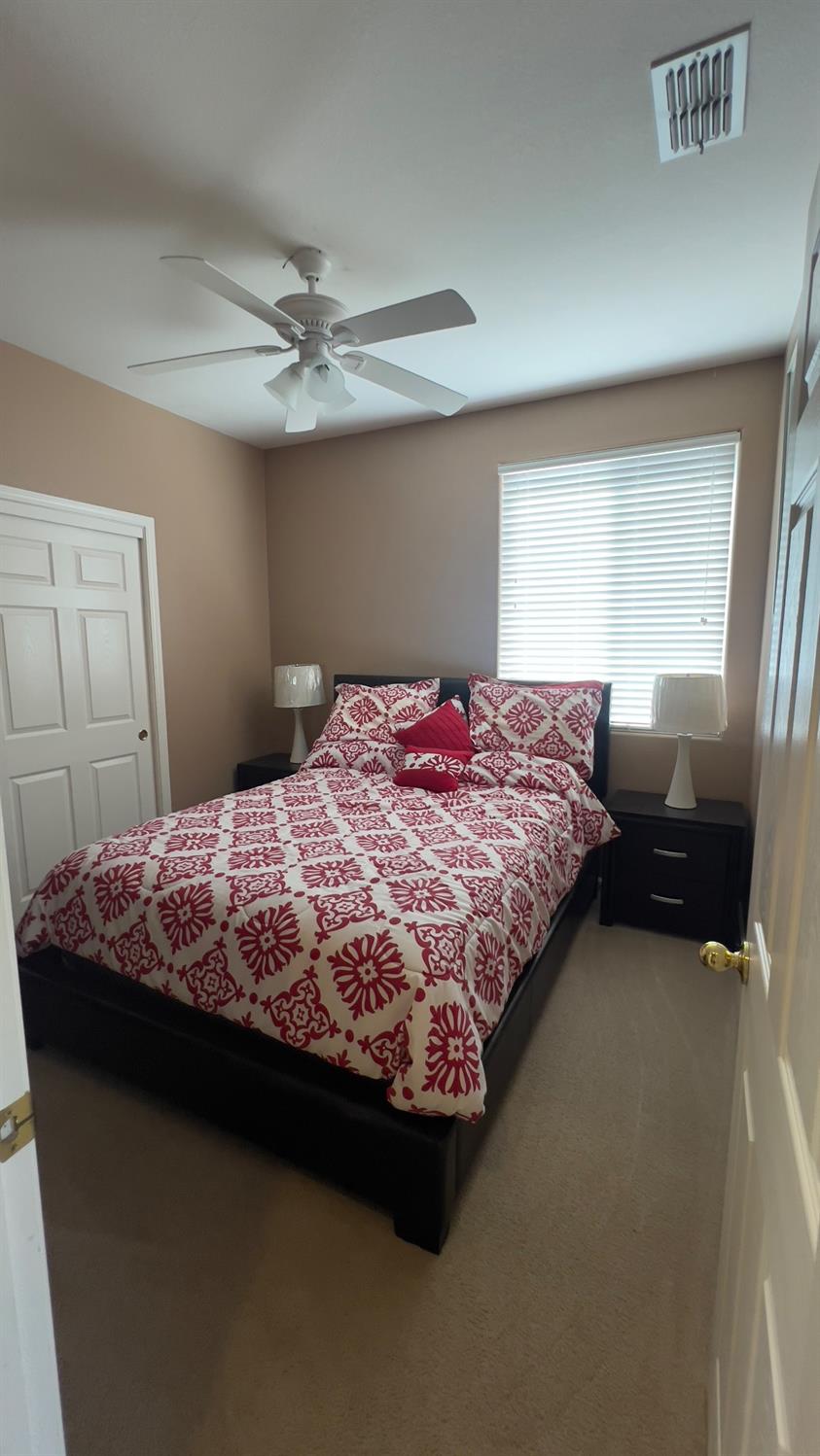 5221 East Byrd Avenue Fresno, CA 93725 - Photo 10 of 15 a bedroom with a bed dresser and window