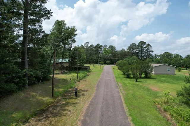 a view of a chair and fire pit in the middle of the yard
