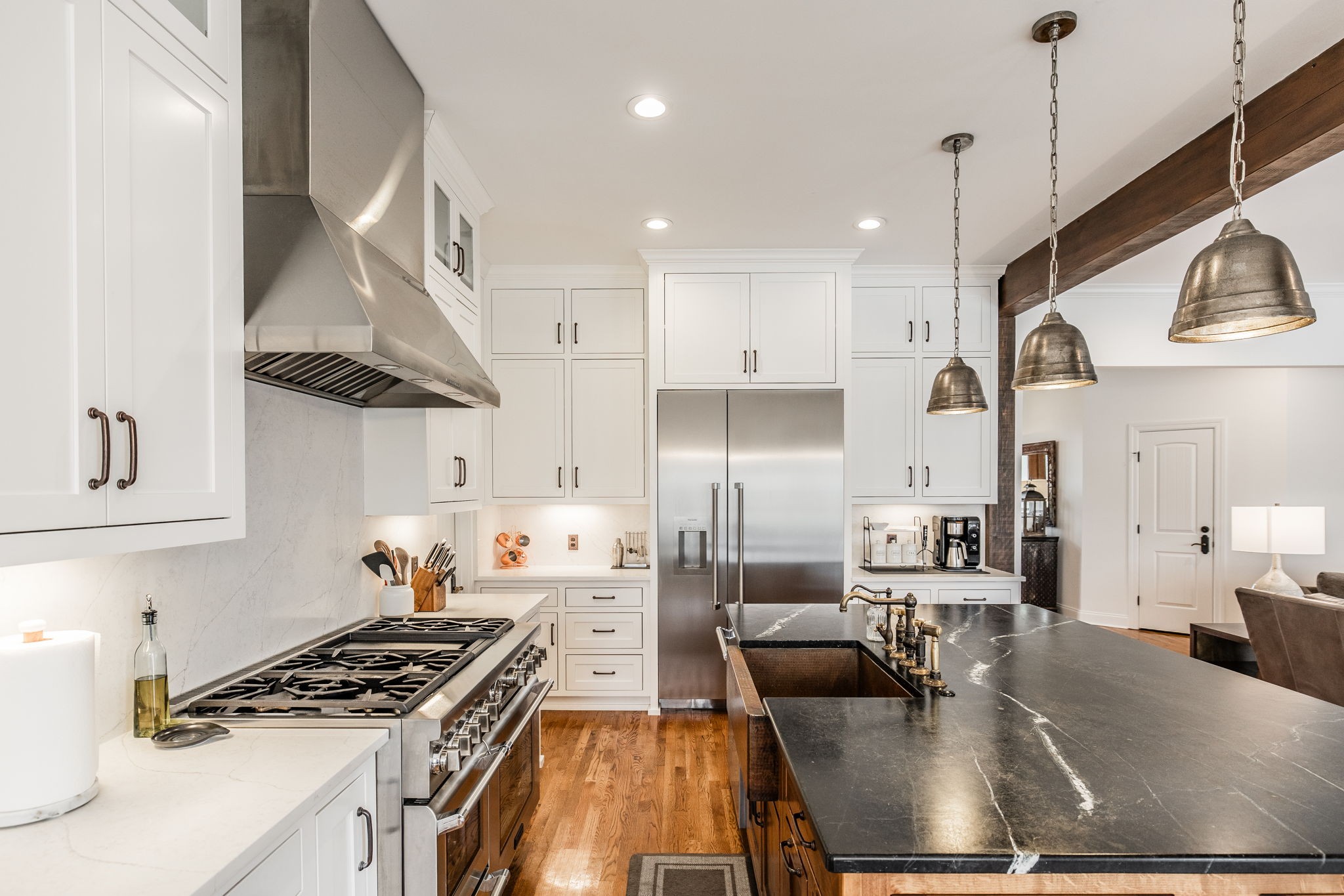 8137 Shoals Branch Road Primm Springs, TN 38476 - Photo 11 of 69 a kitchen with stainless steel appliances granite countertop a sink a stove and a wooden floors