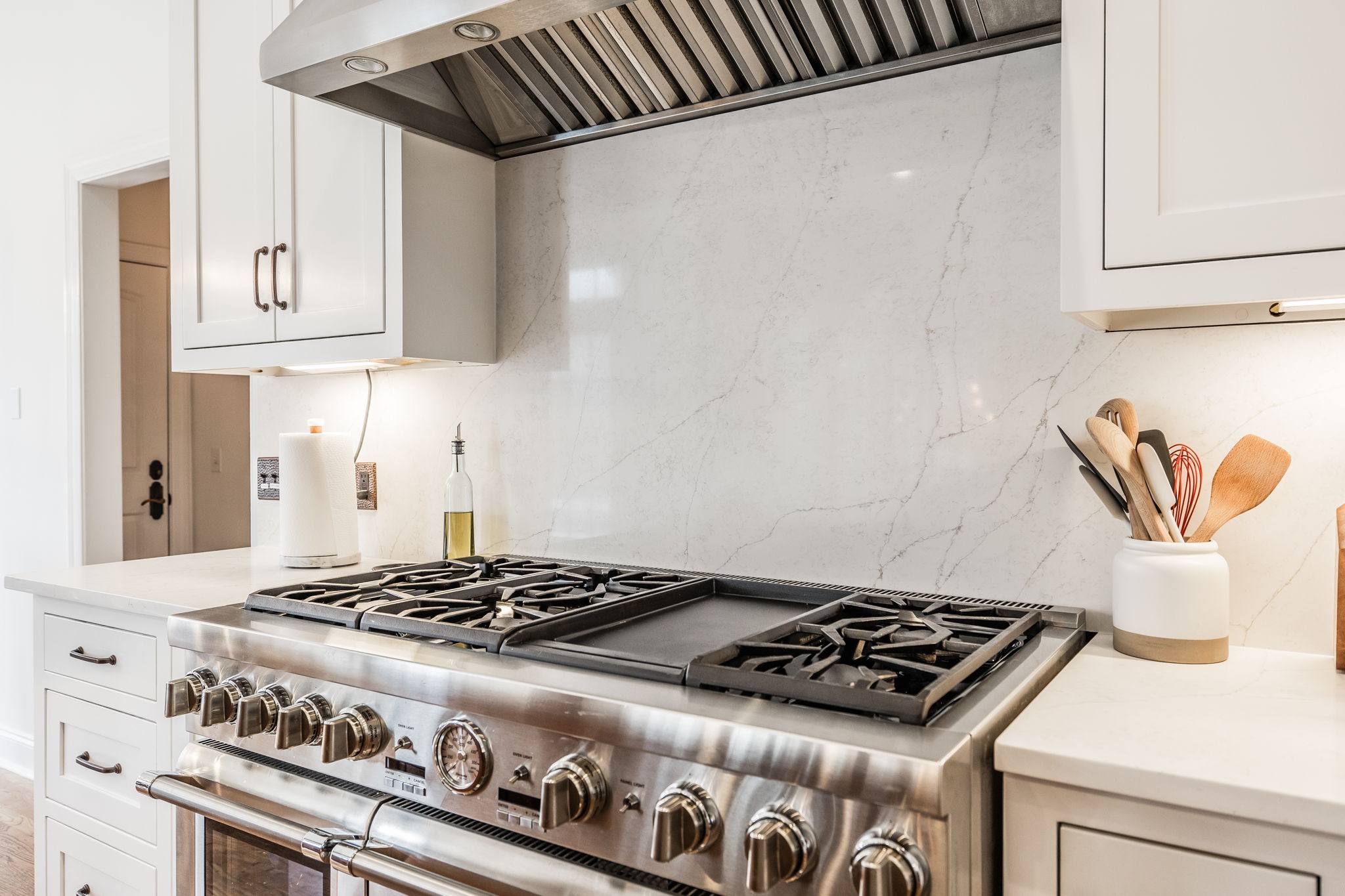 8137 Shoals Branch Road Primm Springs, TN 38476 - Photo 13 of 69 a stove sitting inside of a kitchen with white cabinets