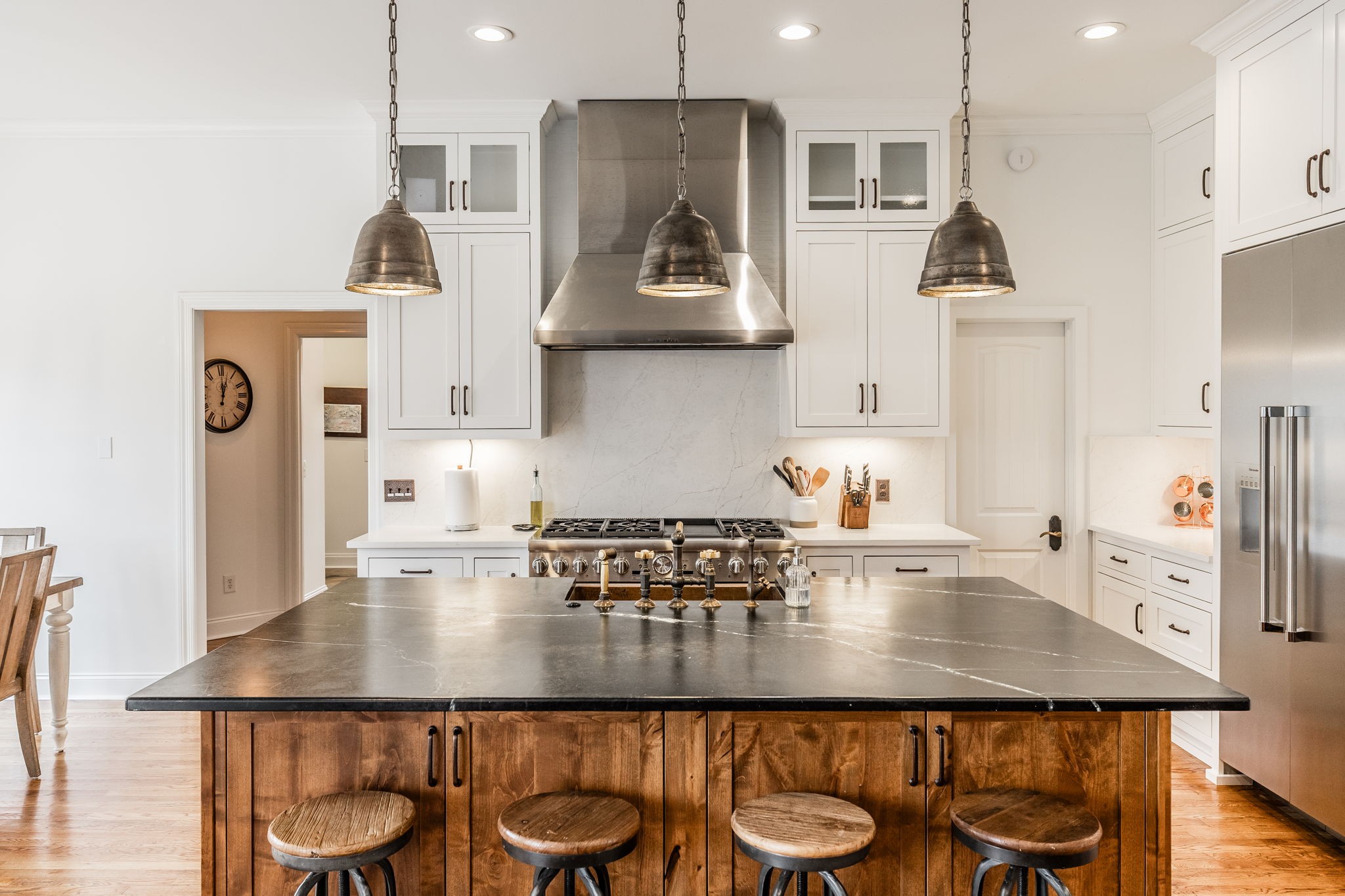 8137 Shoals Branch Road Primm Springs, TN 38476 - Photo 10 of 69 a kitchen with granite countertop a table chairs stove and cabinets