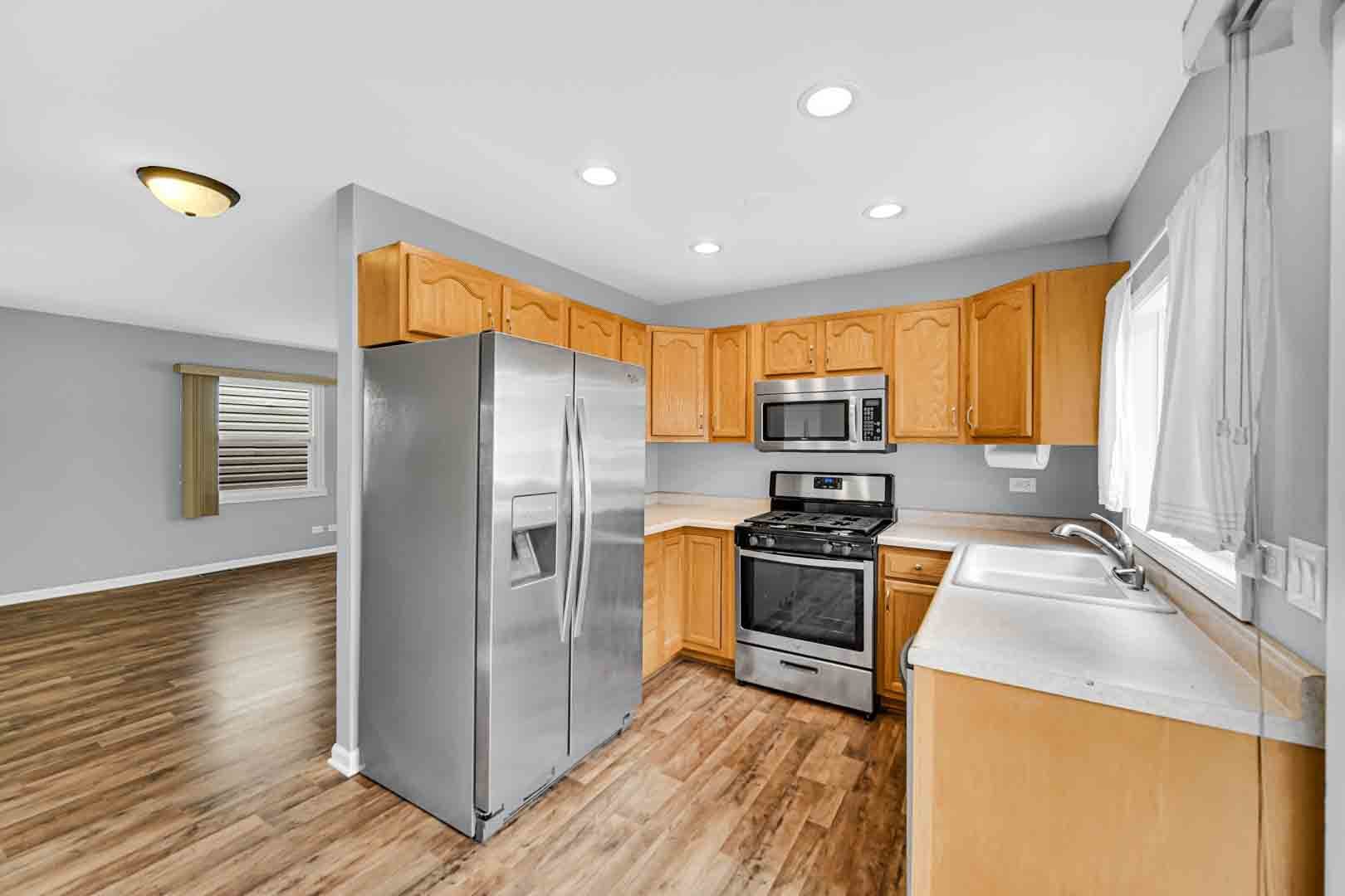 9215 Fox Court Orland Hills, IL 60487 - Photo 11 of 21 a kitchen with stainless steel appliances granite countertop a refrigerator a stove top oven a sink and dishwasher