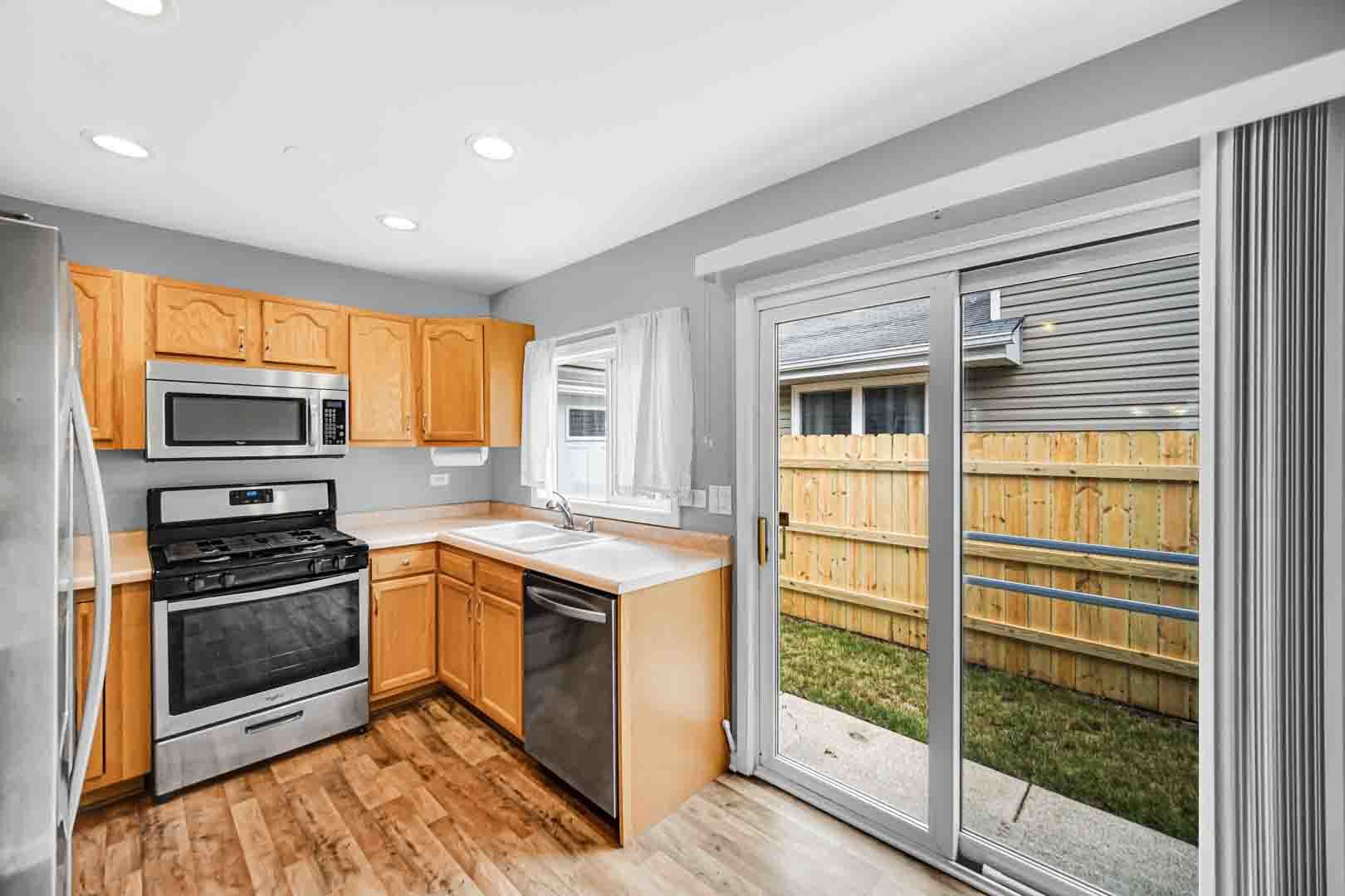 9215 Fox Court Orland Hills, IL 60487 - Photo 12 of 21 a kitchen with stainless steel appliances granite countertop a stove and a refrigerator