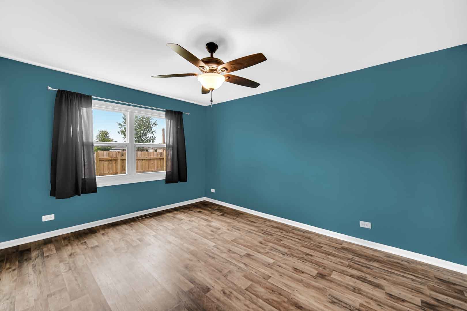 9215 Fox Court Orland Hills, IL 60487 - Photo 14 of 21 an empty room with wooden floor fan and windows