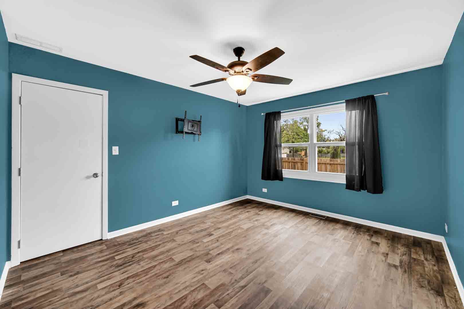 9215 Fox Court Orland Hills, IL 60487 - Photo 16 of 21 a view of an empty room with window and wooden floor